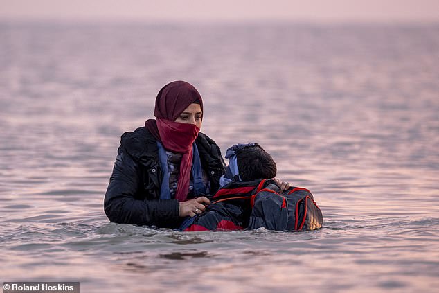 Former Tory Cabinet minister Sir Jacob Rees-Mogg said the Anglo-French deal was a 'complete waste of time'. Pictured: Migrants waiting for a small boat at Gravelines beach today
