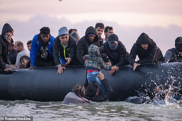 'It's a fake. It's a phony, it's a cheat on the British people,' he said on GB News. Pictured: Migrants waiting for a small boat on Gravelines beach today