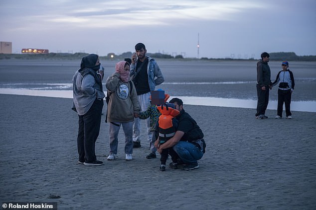 That element of the scheme also began on Thursday, allowing migrants to lodge 'expressions of interest' on a specially-created Home Office website. Pictured: Passengers waiting for a boat at Gravelines beach today
