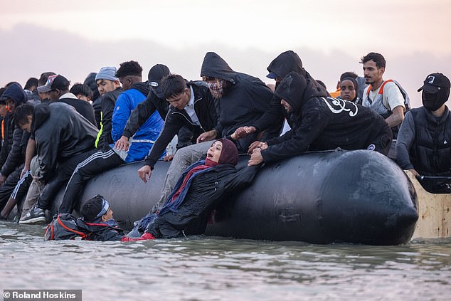 As part of the treaty, Britain will accept migrants from France in exchange for small boat arrivals. Pictured: Passengers loading on to a boat at Gravelines beach today
