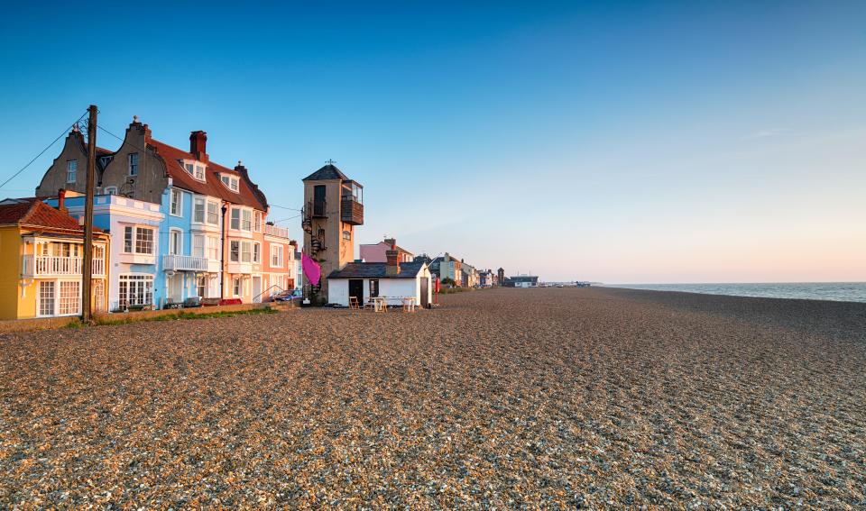 Aldeburgh beach in Suffolk, England, with colorful houses.