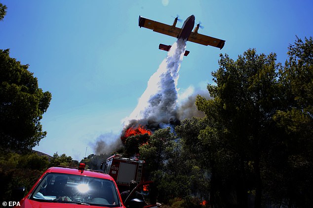 A firefighting airplane in action amid a wildfire that broke out in the area of Keratea, Southeast Attica, Greece, 09 August 2025