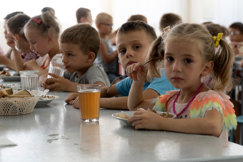 Children from a Ukrainian orphanage eating a meal.
