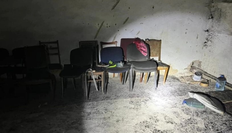 Alleged torture chamber in Kherson with chairs and debris on the floor.