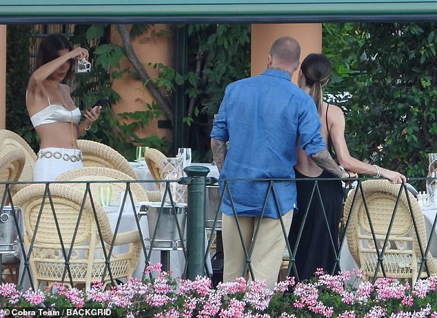 Jackie could be seen snapping candid moments of power couple David and Victoria as they cosied up for the camera