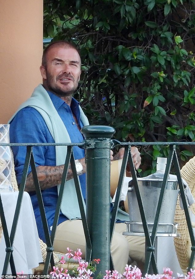 David looked stylish in a bright blue shirt with beige trousers