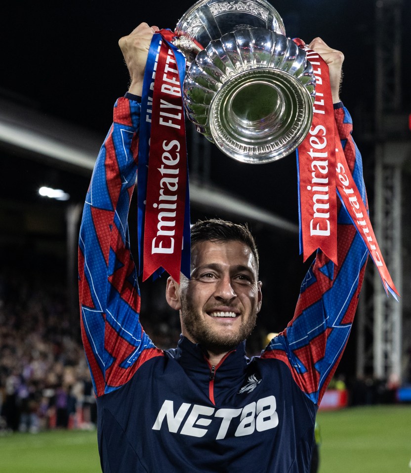 Joel Ward of Crystal Palace holding up the FA Cup.