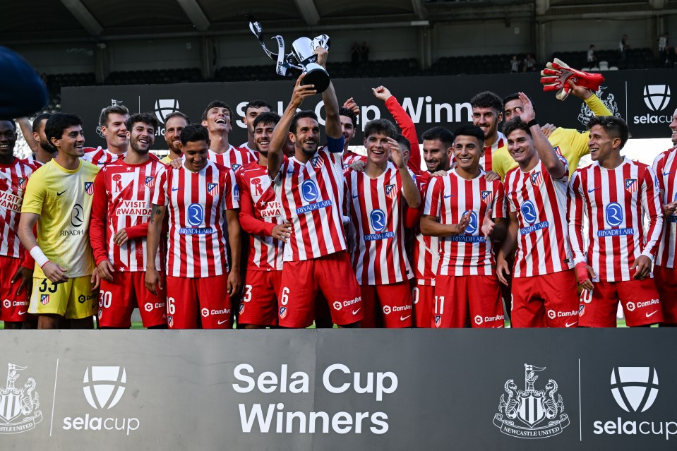 Atletico Madrid players celebrating Sela Cup victory.