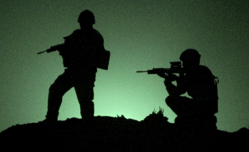 Silhouette of two soldiers with rifles.