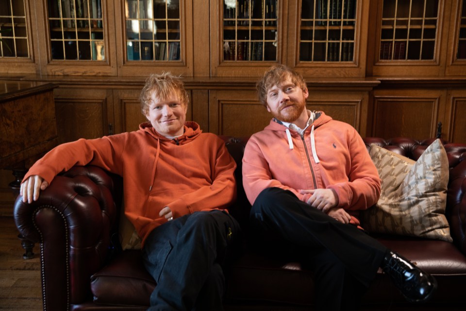 Ed Sheeran and Rupert Grint sitting on a couch.