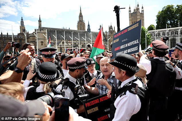 During a day of chaos and farce, Left-wing activists swamped Parliament Square in London today in support of the organisation, which was proscribed by the Government last month as a terrorist group