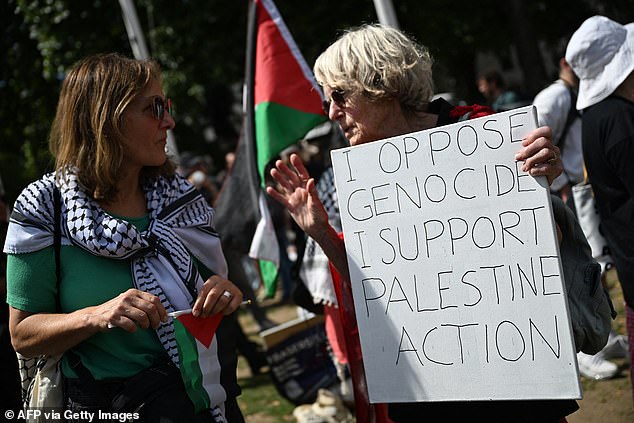 Protesters held signs vowing support for Palestine Action in Parliament Square today