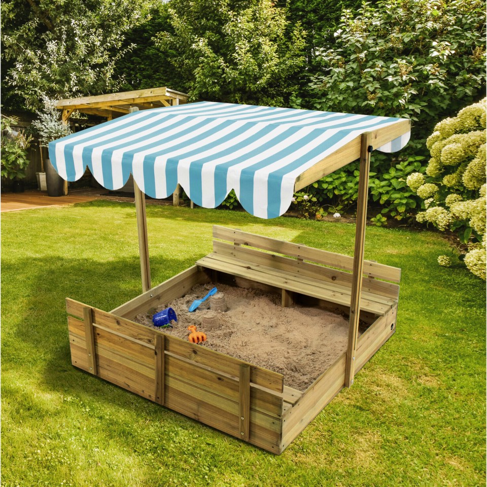 Wooden sandbox with striped canopy and built-in benches.