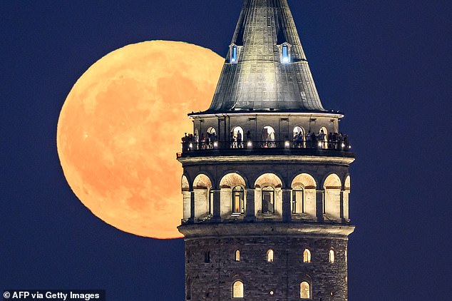 Here it rises over the Galata Tower in Istanbul