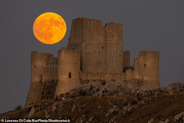 The Sturgeon full moon rises behind Rocca Calascio castle in Italy
