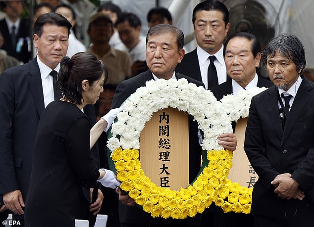 At 11:02am yesterday, the exact time when the plutonium bomb exploded above Nagasaki, officials from more than 90 countries joined in a moment of silence at the peace park as a bell rang. Pictured: Japanese Prime Minister Shigeru Ishiba