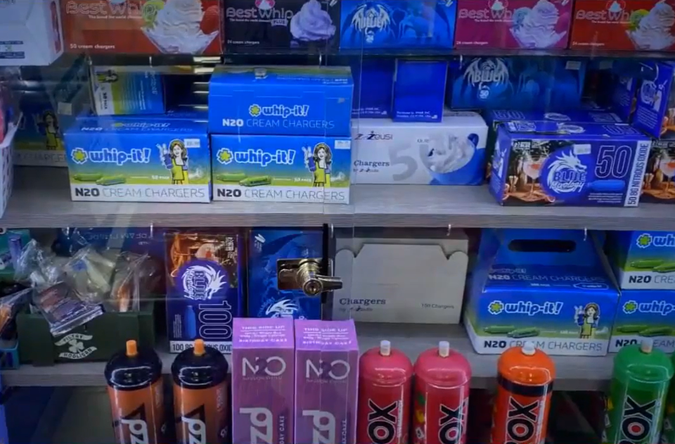 N2O cream chargers and other nitrous oxide products displayed on shelves.