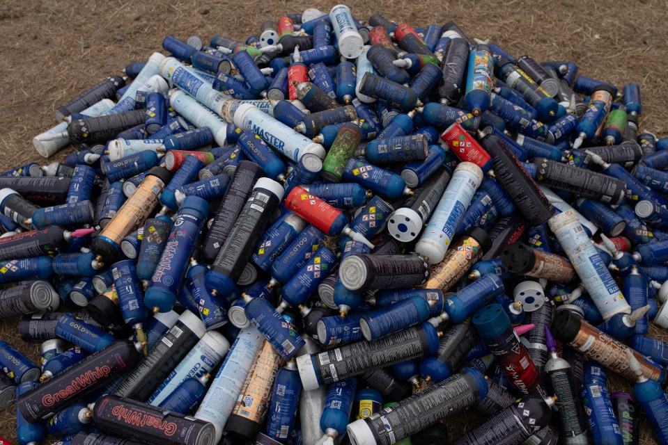 Pile of discarded nitrous oxide canisters at a music festival.
