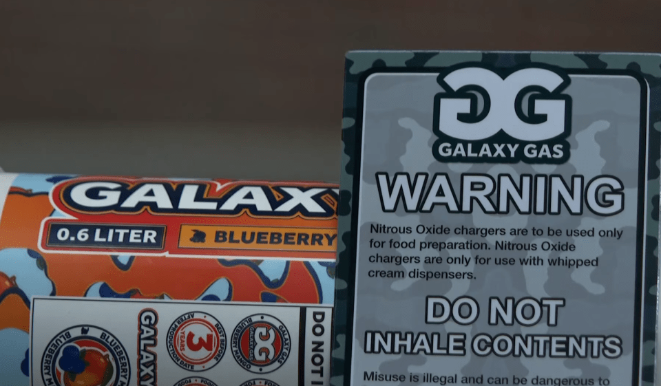 Warning label for Galaxy Gas nitrous oxide chargers; misuse is illegal and dangerous.