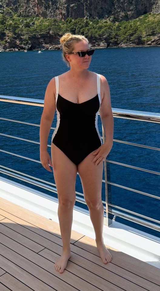 Amy Schumer in a swimsuit on a boat.