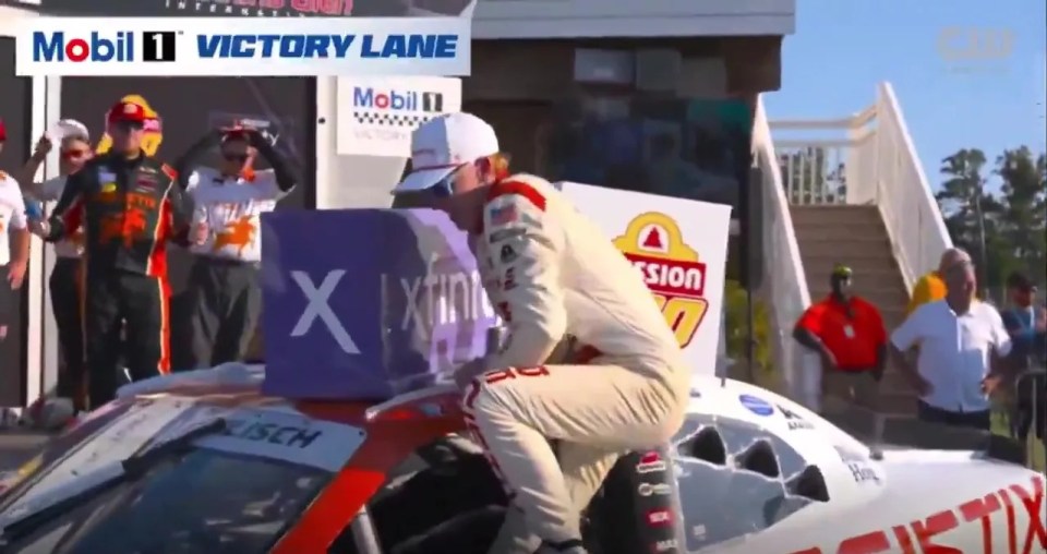 Connor Zilisch falling after winning a NASCAR Xfinity Series race.