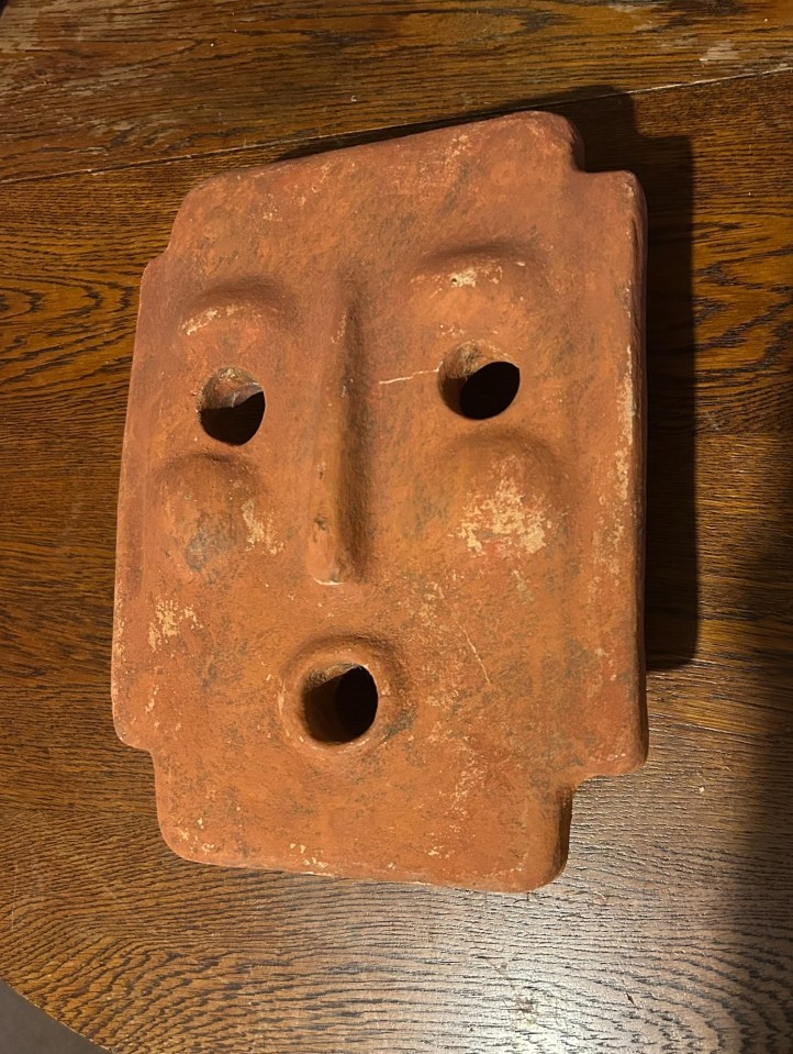 Terracotta mask tea light sconce.