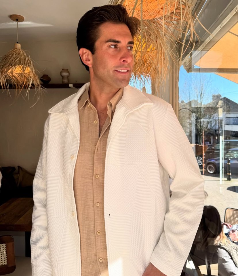 Man in white jacket and beige shirt.