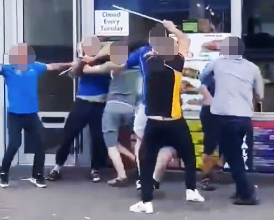 A street brawl involving several people wielding weapons.