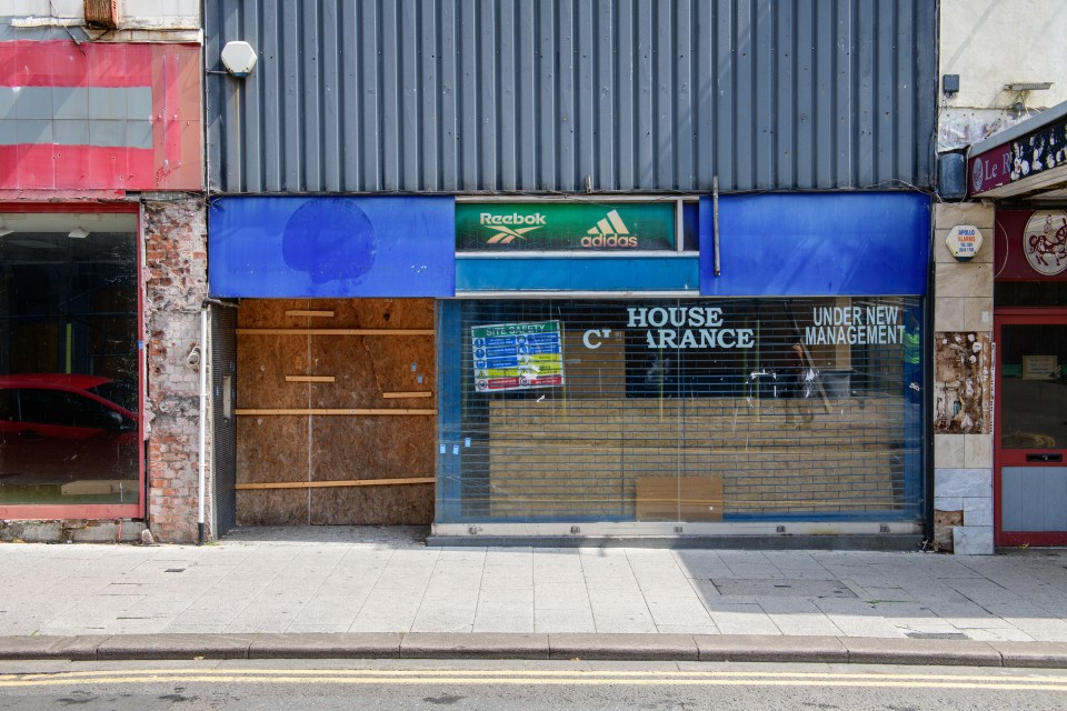 Boarded-up sports shop on Commercial Street.