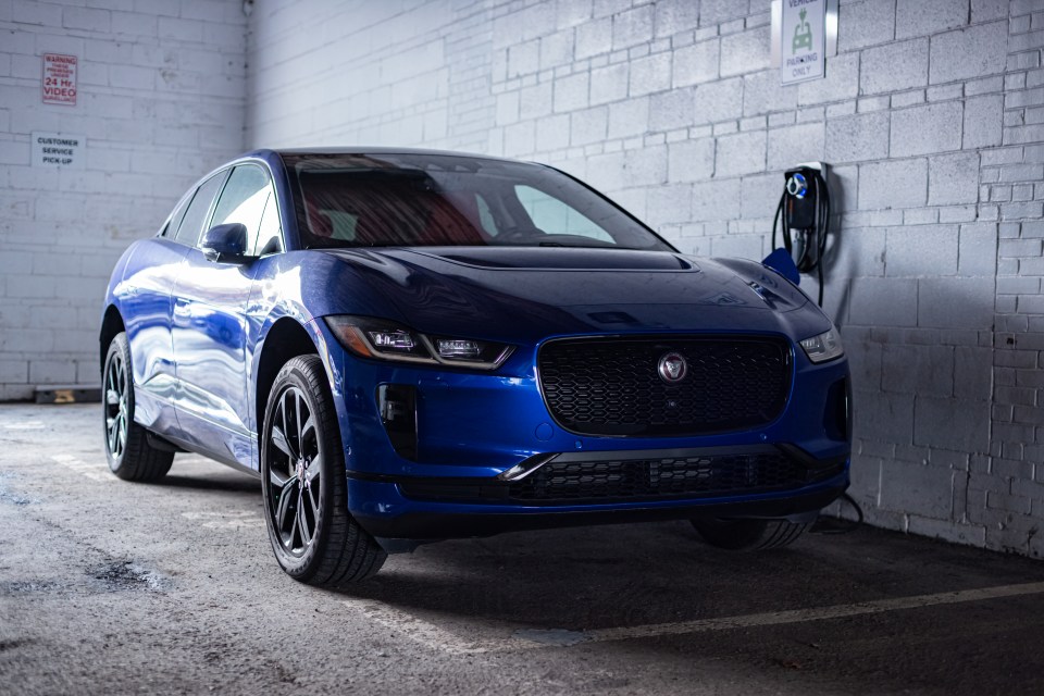Blue Jaguar I-Pace EV400 charging at a dealership.