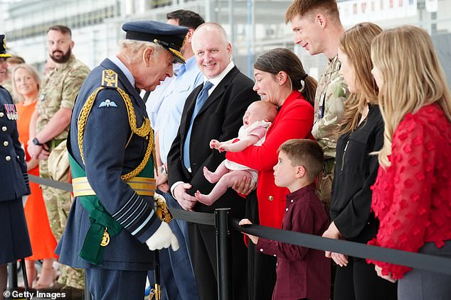 He later met with the personnel and their relatives, including some based in Cyprus and Poland, where they are defending Nato's eastern borders. Pictured: The King meeting RAF soldiers and their families on his visit to RAF Lossiemouth