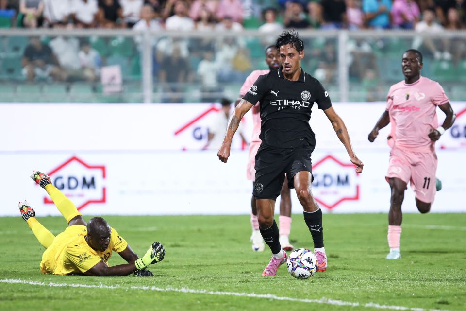Tijjani Reijnders of Manchester City FC dribbling the ball during a soccer match.