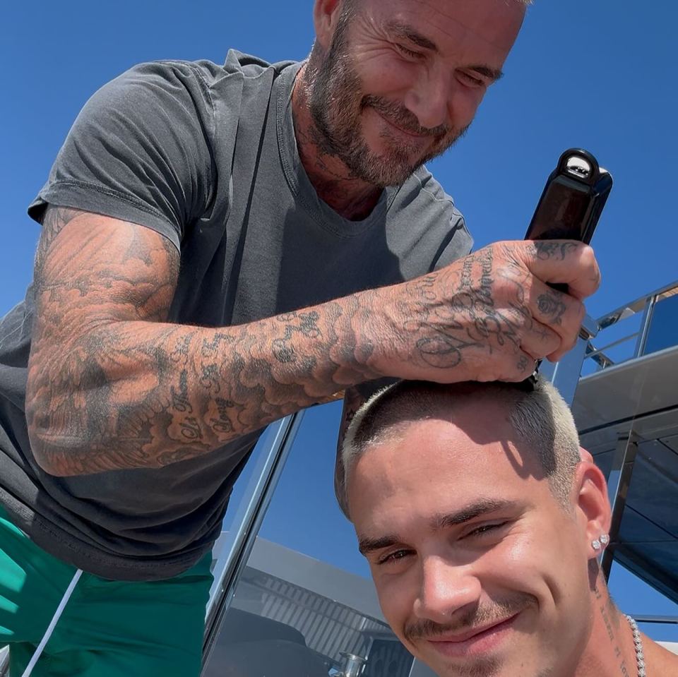 Man shaving another man's head.