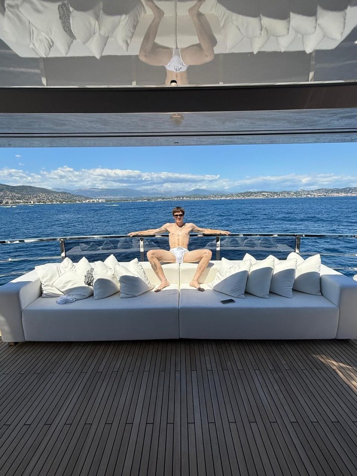 Man in white briefs relaxing on a yacht.