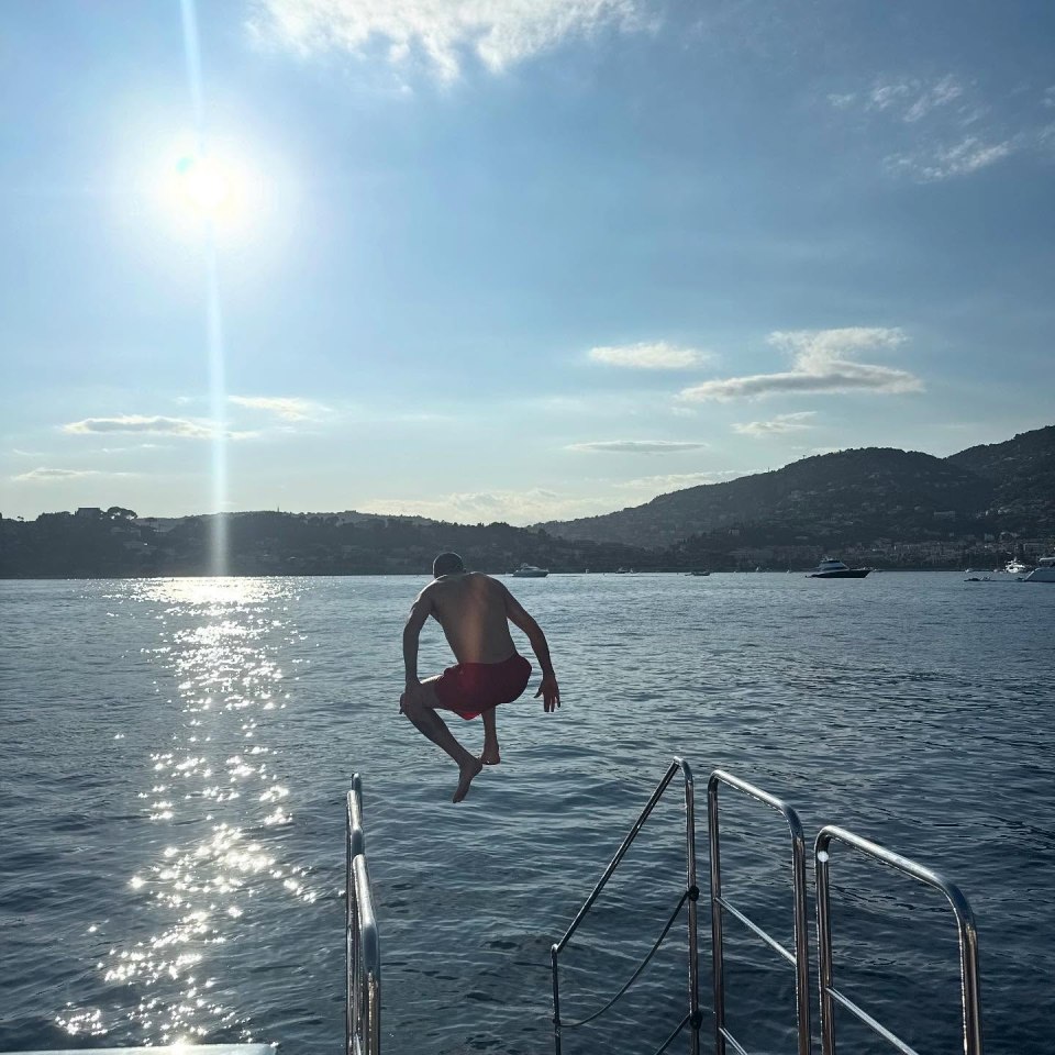 Man jumping into ocean from boat.