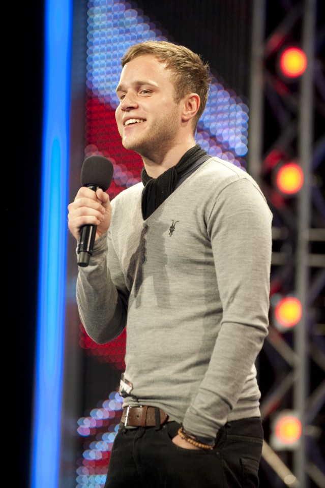 Olly Murs holding a microphone at an X Factor audition.