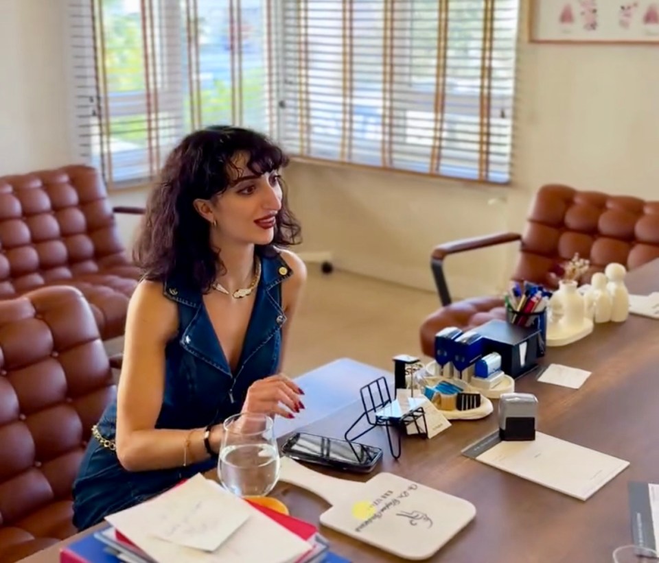Woman sitting at a conference table during a business meeting.