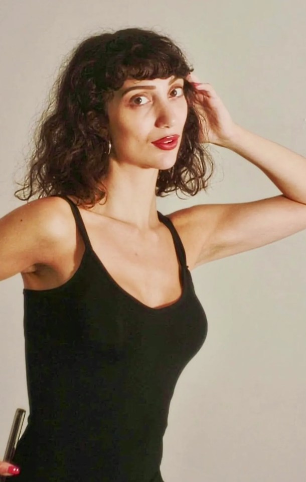 Woman in black tank top.