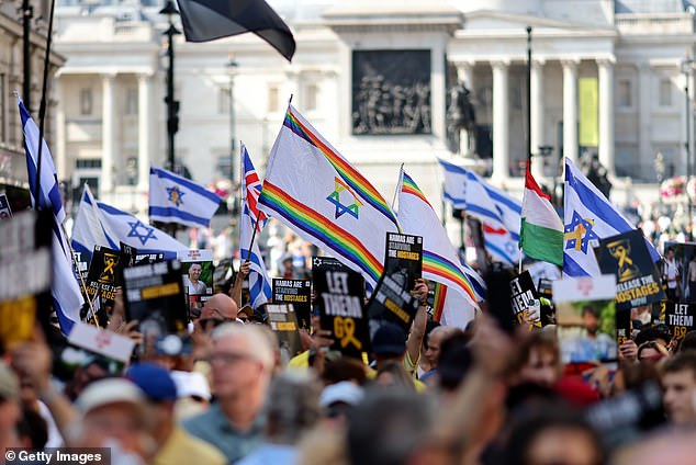 Israeli flags - as well as rainbow-coloured Pride flags - were carried by some protesters. Others held pictures of some of the captive Israel hostages