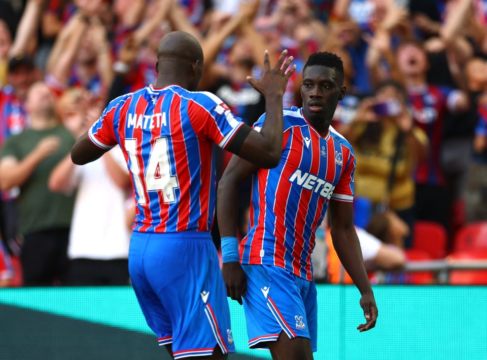 Ismaila Sarr and Jean-Philippe Mateta celebrating a goal.