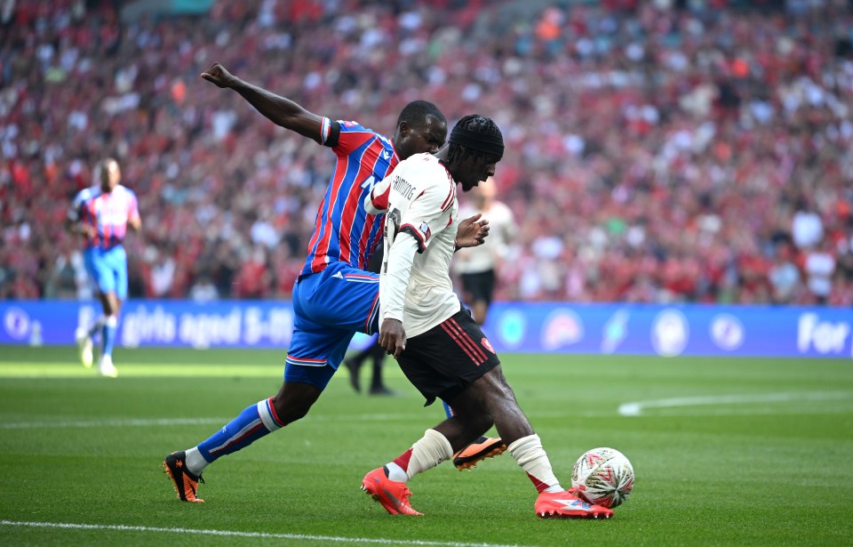 Jeremie Frimpong of Liverpool scores a goal, defended by Tyrick Mitchell of Crystal Palace.