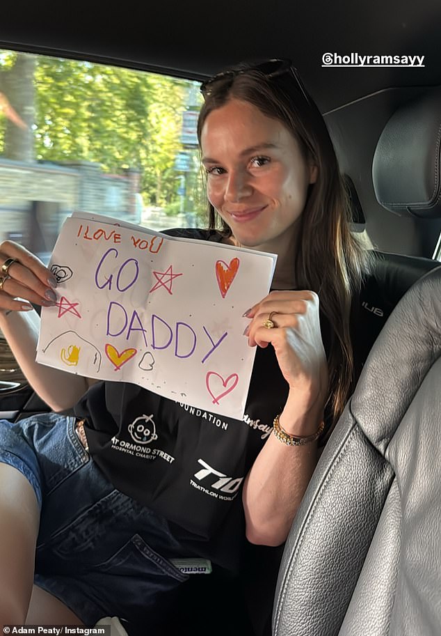 The Olympian took to his Instagram Story to share a picture of his wife-to-be Holly in the car on the way to the race, as she held a poster from his son reading: 'I love you. Go daddy!'