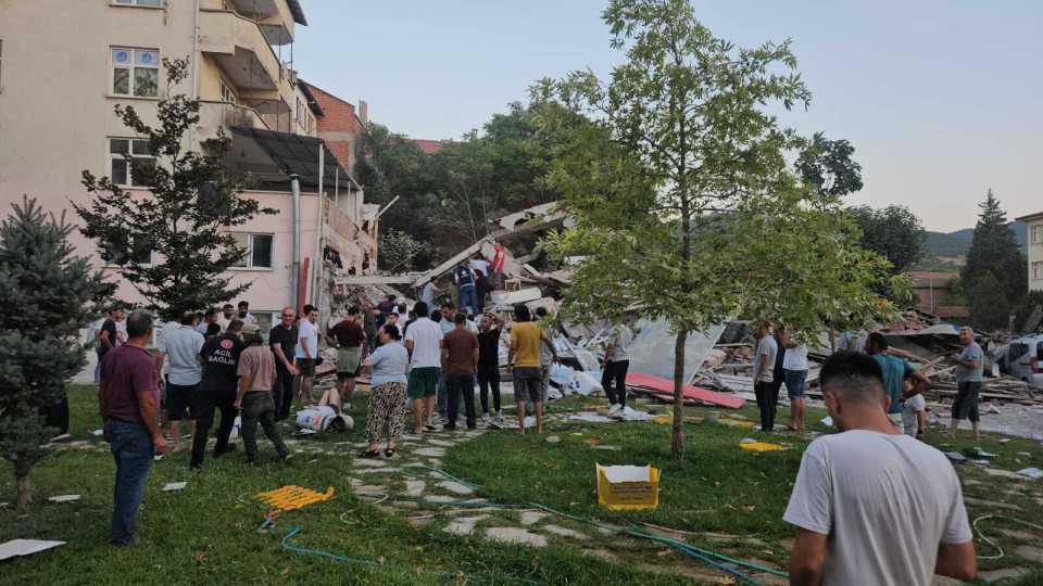 Search and rescue teams at the site of a collapsed building.
