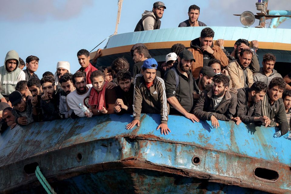 Rescued refugees and migrants on a boat.