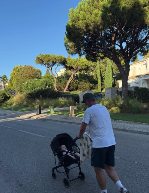 Man pushing a baby in a stroller.