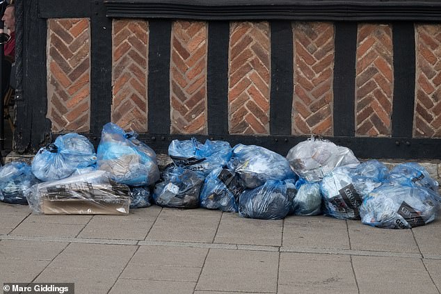 Rubbish bags left by stores at the corner of the street when walking into Henley Street