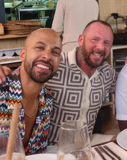 Four men seated together at a restaurant table.