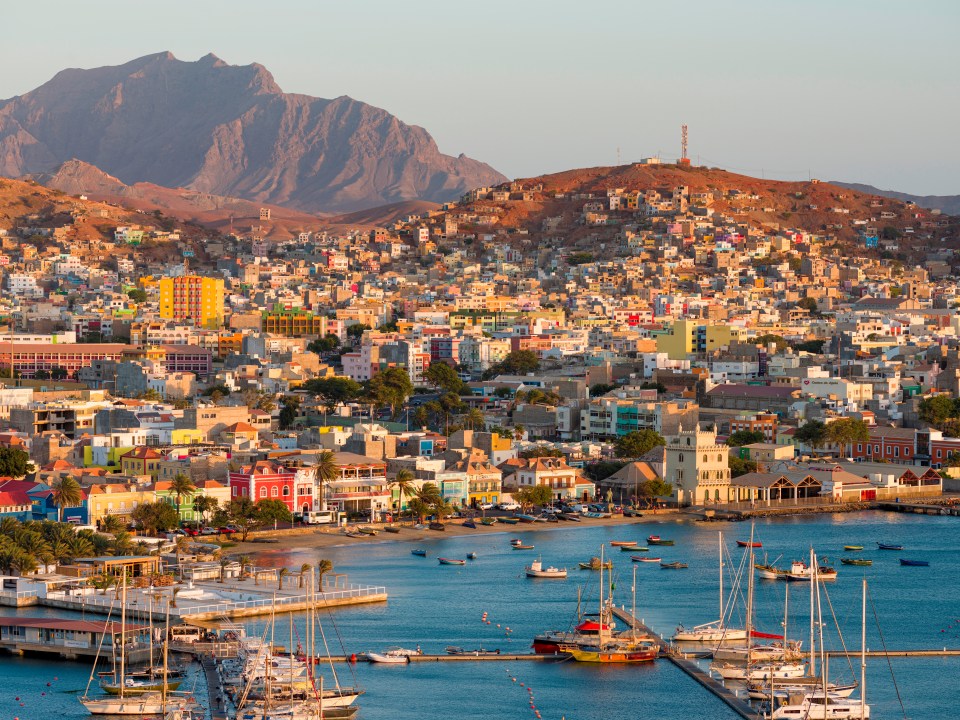 Aerial view of Mindelo, Cape Verde, showing the city, harbor, and boats.
