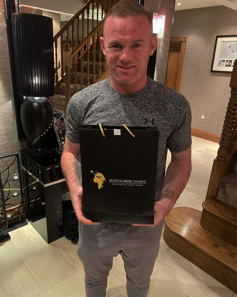 Wayne Rooney holding an Avant-Garde Global luxury goods bag.