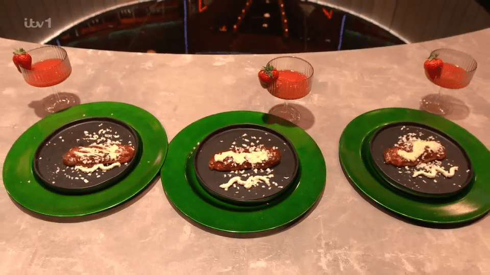 Three plates of food garnished with white sauce and crumbs, next to strawberry cocktails.